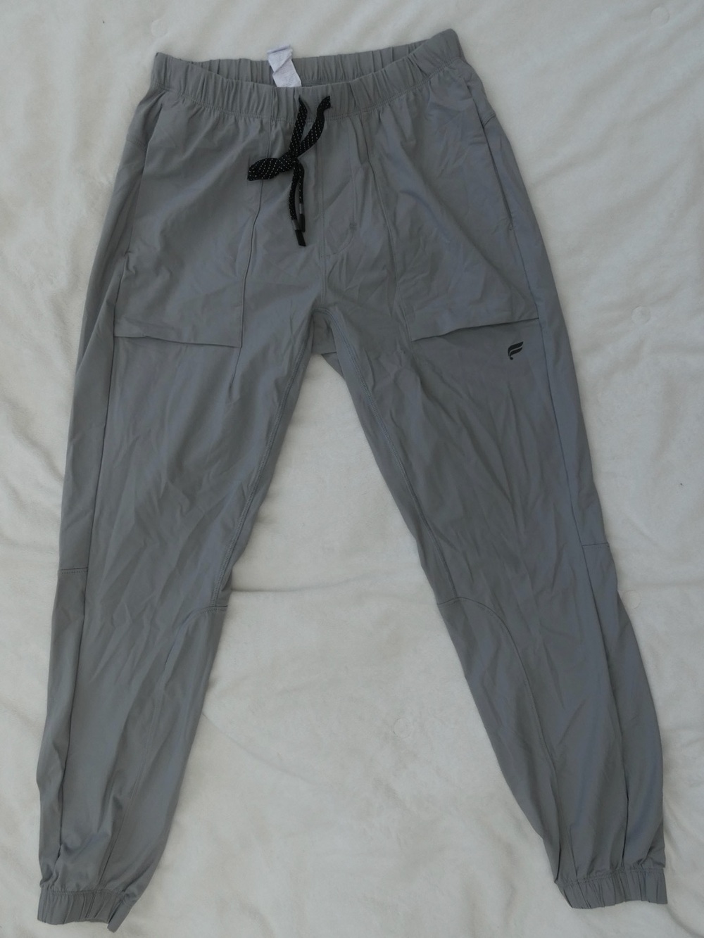 The One Fabletics gray athletic joggers with an elastic waistband. Men’s.